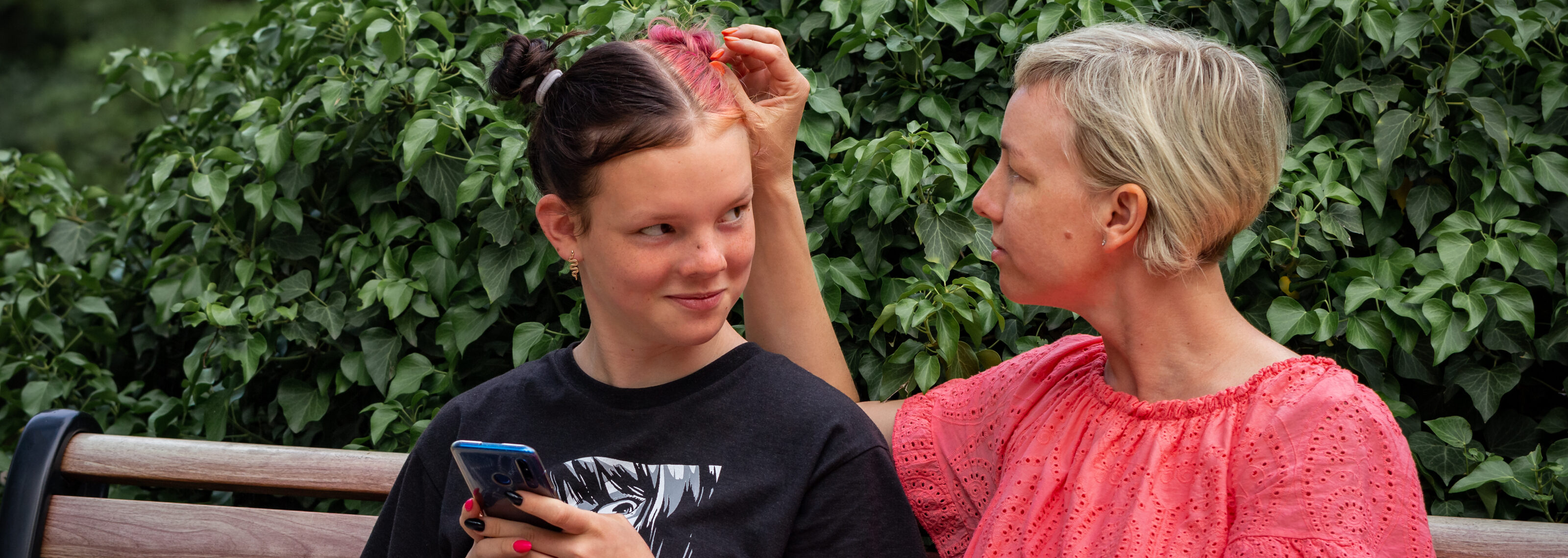 Mother discusses with rebellious teenage daughter in the park